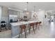 Stylish kitchen featuring a spacious island with bar seating, stainless steel appliances, and modern pendant lights at 8913 Coconut Breeze Dr, Kissimmee, FL 34747