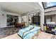Spacious covered patio featuring lounge chairs, dining table, and grill, ideal for outdoor living at 8913 Coconut Breeze Dr, Kissimmee, FL 34747