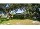 Lush backyard featuring a gazebo, screened pool enclosure, mature trees, and play structure at 901 Candle Berry Rd, Orlando, FL 32825