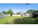 Spacious backyard with a white fence, shed, and green grass provides a private outdoor space at 901 Candle Berry Rd, Orlando, FL 32825