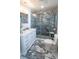 Bathroom featuring a glass shower, toilet, and granite floors at 901 Candle Berry Rd, Orlando, FL 32825