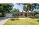 Charming single-story home featuring well-maintained lawn and stone accents at 901 Candle Berry Rd, Orlando, FL 32825