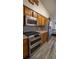 Well-lit kitchen showcasing a double oven, stainless steel refrigerator, and wooden cabinets at 901 Candle Berry Rd, Orlando, FL 32825