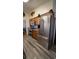 Updated kitchen with stainless steel appliances, mosaic backsplash, and wooden cabinets at 901 Candle Berry Rd, Orlando, FL 32825