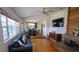 Bright living room connected to the dining area, featuring a fireplace and hardwood floors at 901 Candle Berry Rd, Orlando, FL 32825