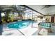 Enclosed pool with sun-drenched patio including seating, grilling area, and ceiling fans for entertaining at 901 Candle Berry Rd, Orlando, FL 32825