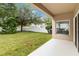 A view of the home's backyard featuring a well-maintained lawn and mature trees at 9067 Stonebury Way, Orlando, FL 32832