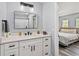 Well-lit bathroom with a white vanity, black hardware, and a shower with white subway tile at 9067 Stonebury Way, Orlando, FL 32832
