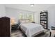 Bedroom with modern decor, ceiling fan, hardwood floors, and natural light at 9067 Stonebury Way, Orlando, FL 32832