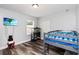 Bedroom with a bunk bed, wood-look flooring, and a window for natural light at 9067 Stonebury Way, Orlando, FL 32832
