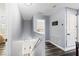 Upstairs Hallway with hardwood floors and access to bedrooms and staircase at 9067 Stonebury Way, Orlando, FL 32832