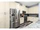 Kitchen features stainless steel appliances, ample cabinetry, granite countertops, and new floors at 9067 Stonebury Way, Orlando, FL 32832