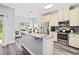 Kitchen features stainless steel appliances, ample cabinetry, granite countertops, and new floors at 9067 Stonebury Way, Orlando, FL 32832