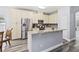 Kitchen features stainless steel appliances, ample cabinetry, granite countertops, and new floors at 9067 Stonebury Way, Orlando, FL 32832
