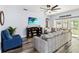 Comfortable living room features a ceiling fan, hardwood floors, and modern decor at 9067 Stonebury Way, Orlando, FL 32832
