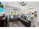 Living Room with a cozy gray sectional sofa and natural lighting from sliding glass doors at 9067 Stonebury Way, Orlando, FL 32832