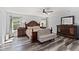 Spacious bedroom with hardwood floors, large windows, and classic furniture at 9067 Stonebury Way, Orlando, FL 32832
