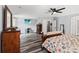 Comfortable main bedroom with ceiling fan, hardwood floors, and modern decor at 9067 Stonebury Way, Orlando, FL 32832