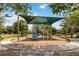 Community playground with a shade structure, slide, and play equipment for enjoyment at 9067 Stonebury Way, Orlando, FL 32832