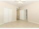 Tile bedroom with closet doors, doorways and ceiling fan at 911 N Orange Ave # 143, Orlando, FL 32801