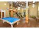 Expansive clubhouse featuring a pool table, seating area, and high ceilings with exposed beams for a stylish community space at 911 N Orange Ave # 143, Orlando, FL 32801