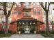 Inviting building entrance featuring grand doors, decorative lighting, and professional landscaping at 911 N Orange Ave # 143, Orlando, FL 32801