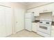 Bright kitchen features white appliances and cabinets with tile floor at 911 N Orange Ave # 143, Orlando, FL 32801