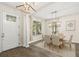 Elegant dining area featuring stylish lighting fixtures, a wooden table, and comfortable seating at 10117 Sweetleaf St, Orlando, FL 32827