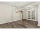 Spacious dining area with french doors, hardwood floors, and modern lighting at 10117 Sweetleaf St, Orlando, FL 32827
