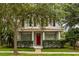 Inviting front porch view with a red front door and a well-kept lawn at 10117 Sweetleaf St, Orlando, FL 32827