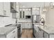 Modern kitchen boasts stainless steel appliances, granite countertops, and stylish cabinets at 10117 Sweetleaf St, Orlando, FL 32827