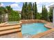 Backyard swimming pool featuring a waterfall and integrated hot tub surrounded by lush landscaping at 10117 Sweetleaf St, Orlando, FL 32827