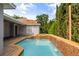 Swimming pool and hot tub featuring a waterfall and patio area on a grey house at 10117 Sweetleaf St, Orlando, FL 32827