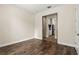 Versatile room with wood-look flooring and doorway view to a light and bright kitchen at 10117 Sweetleaf St, Orlando, FL 32827