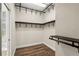 Organized walk-in closet featuring modern black shelving and wood-look floors at 10117 Sweetleaf St, Orlando, FL 32827