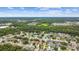 Scenic aerial view of a residential area near a lake and wooded areas at 1041 Cherry Valley Way, Orlando, FL 32828