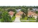 Aerial view of a well-maintained single-Gathering home with a manicured lawn, mature trees, and two-car garage at 1041 Cherry Valley Way, Orlando, FL 32828
