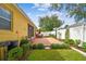 Spacious backyard with a brick patio, lush greenery, and an inviting outdoor dining set at 1041 Cherry Valley Way, Orlando, FL 32828