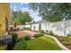 Picturesque backyard featuring a brick patio, lush lawn, and manicured landscaping at 1041 Cherry Valley Way, Orlando, FL 32828