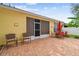 Backyard patio featuring brick pavers, a screened lanai, and comfortable seating for outdoor enjoyment at 1041 Cherry Valley Way, Orlando, FL 32828