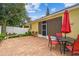 Backyard patio with brick pavers, outdoor seating, and a screened lanai for relaxation and entertaining at 1041 Cherry Valley Way, Orlando, FL 32828