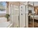 Bright bathroom featuring a glass shower, separate soaking tub, and neutral color palette at 1041 Cherry Valley Way, Orlando, FL 32828