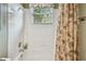 Bright bathroom featuring a tub/shower combo with tiled walls and decorative shower curtain at 1041 Cherry Valley Way, Orlando, FL 32828