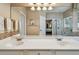 Bathroom featuring double sinks, a large mirror, and a view into the bedroom and walk-in shower at 1041 Cherry Valley Way, Orlando, FL 32828