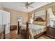 Bedroom featuring a four-poster bed, hardwood floors, and a neutral color palette at 1041 Cherry Valley Way, Orlando, FL 32828