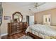 Spacious bedroom featuring a dresser with an ornate mirror, hardwood floors, and a ceiling fan at 1041 Cherry Valley Way, Orlando, FL 32828