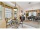 Cozy breakfast nook with a glass table, surrounded by windows and natural light at 1041 Cherry Valley Way, Orlando, FL 32828