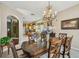 Elegant dining room with a glimpse into the kitchen, featuring hardwood furniture at 1041 Cherry Valley Way, Orlando, FL 32828