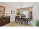 Formal dining room features a chandelier, large window, and traditional decor at 1041 Cherry Valley Way, Orlando, FL 32828