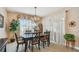 Bright dining room with large window, sheer curtains, and a stylish chandelier at 1041 Cherry Valley Way, Orlando, FL 32828